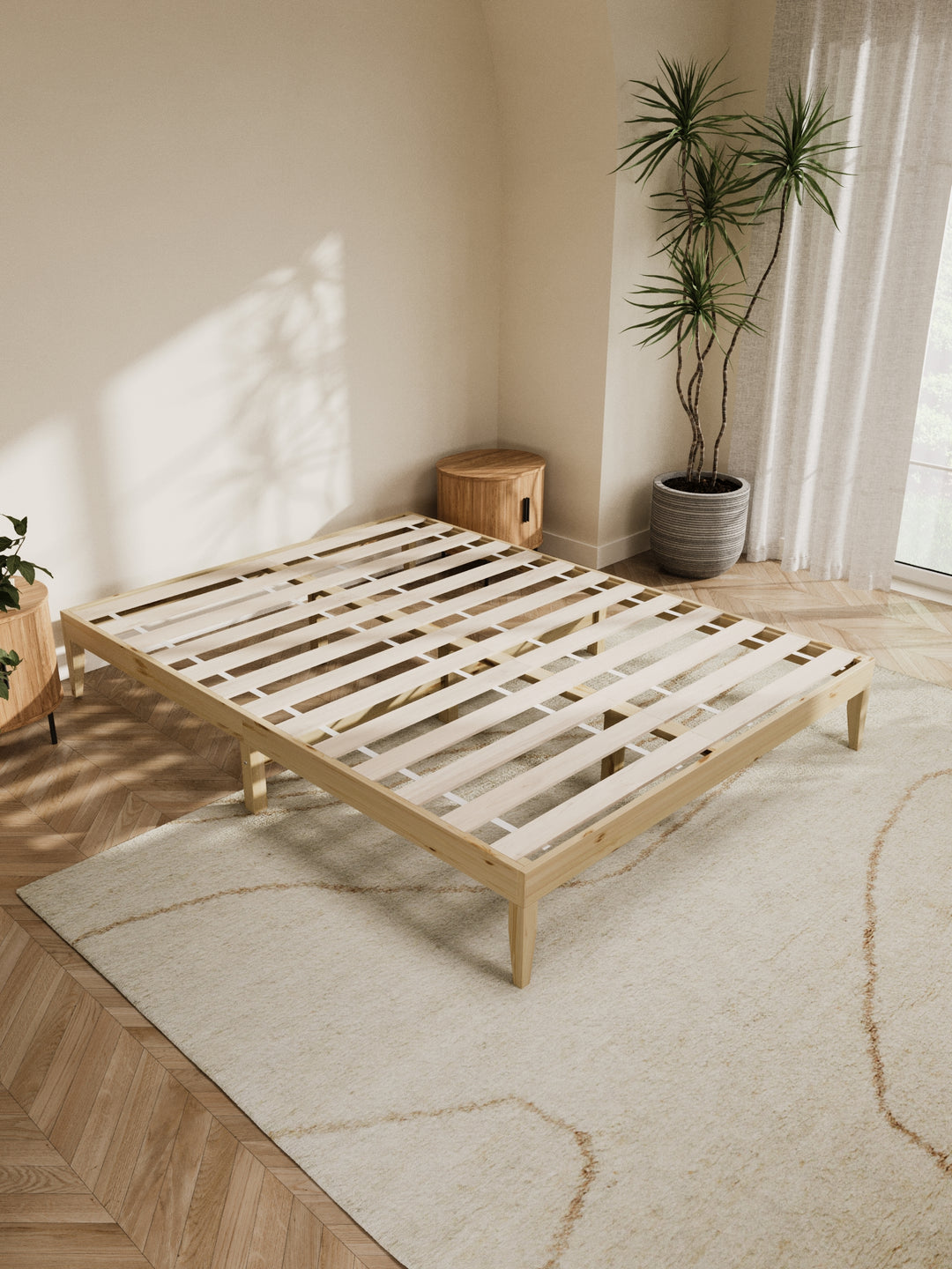 Contemporary bedroom featuring the Ventura Classic Wooden Bed Base in a clean, minimalist design. The natural light highlights the bed's sturdy construction and elegant finish, perfect for those looking to enhance their home with durable, stylish furniture. Paired with soft beige bedding and a lush view from the window, this bed base is ideal for modern décor enthusiasts.