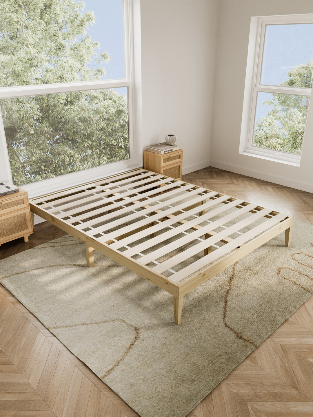 Contemporary bedroom featuring the Ventura Classic Wooden Bed Base in a clean, minimalist design. The natural light highlights the bed's sturdy construction and elegant finish, perfect for those looking to enhance their home with durable, stylish furniture. Paired with soft beige bedding and a lush view from the window, this bed base is ideal for modern décor enthusiasts.